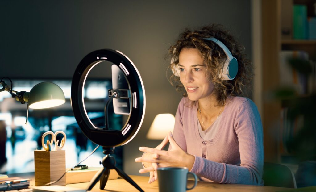 Mujer graba un vídeo para redes sociales frente a su teléfono móvil.