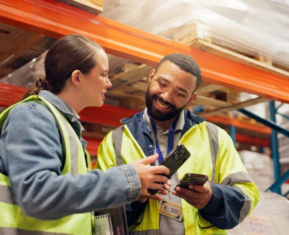 Man,,Woman,And,Phone,At,Warehouse,,Storage,Or,Happy,For